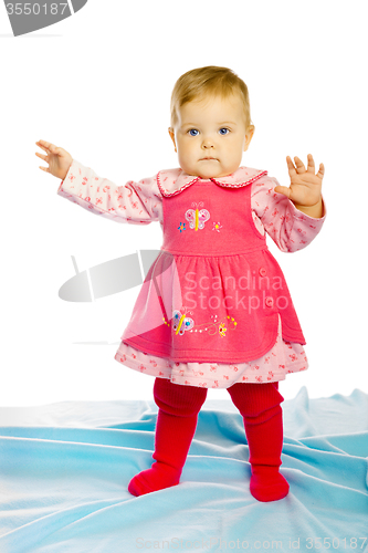 Image of baby girl in a dress standing