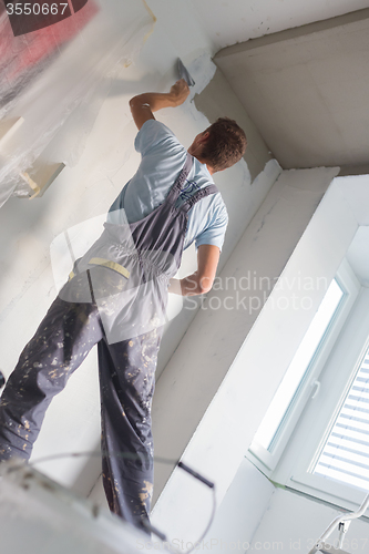 Image of Plasterer renovating indoor walls and ceilings.