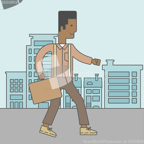 Image of Businessman walking with briefcase. 