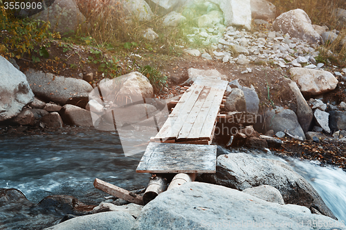 Image of Wooden bridge over small river