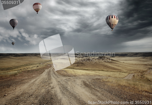 Image of Air balloons over the country road