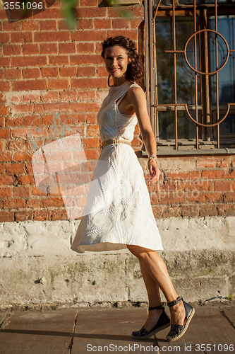 Image of beautiful middle-aged woman in a white dress