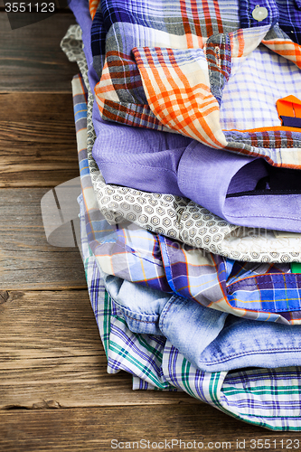 Image of stack of bright colorful shirts