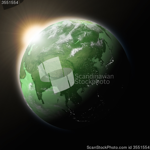 Image of Sun over Southeast Asia on green planet Earth