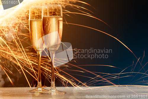 Image of champagne glasses with salute