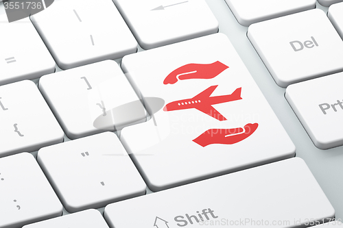 Image of Insurance concept: Airplane And Palm on computer keyboard background