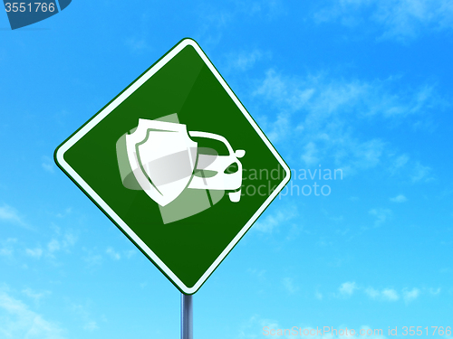 Image of Insurance concept: Car And Shield on road sign background