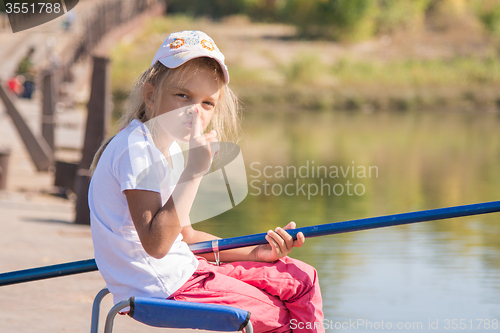 Image of Girl fishing calls for silence