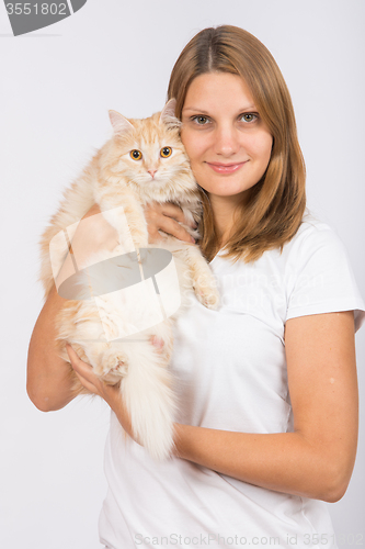 Image of Girl hugging domestic cat