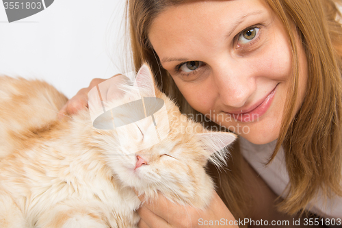 Image of She caresses his domestic cat