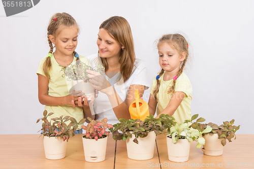 Image of Mom and daughter caring for plants
