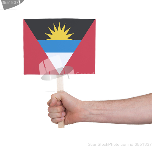 Image of Hand holding small card - Flag of Antigua and Barbuda