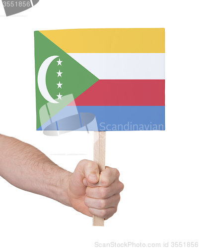 Image of Hand holding small card - Flag of Comoros