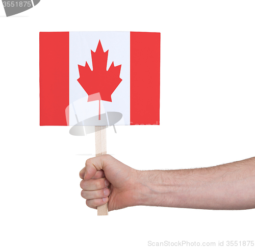 Image of Hand holding small card - Flag of Canada