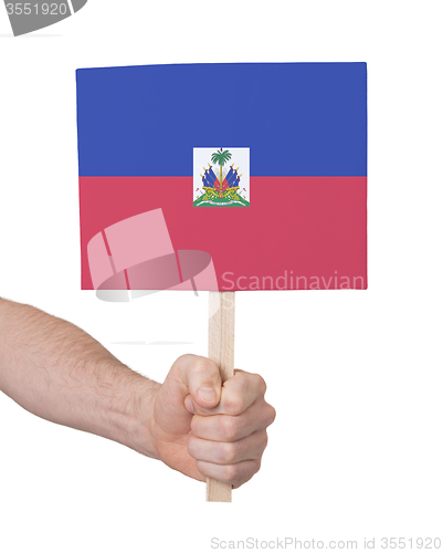 Image of Hand holding small card - Flag of Haiti