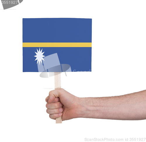 Image of Hand holding small card - Flag of Nauru