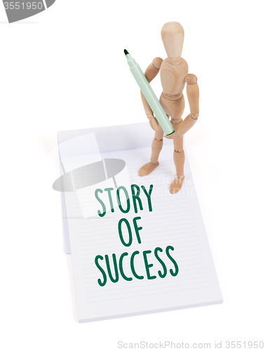 Image of Wooden mannequin writing - Story of success