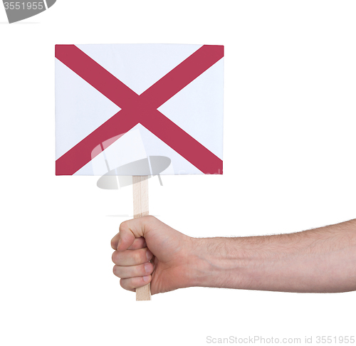 Image of Hand holding small card - Flag of Alabama