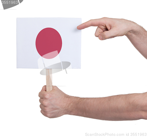 Image of Hand holding small card - Flag of Japan