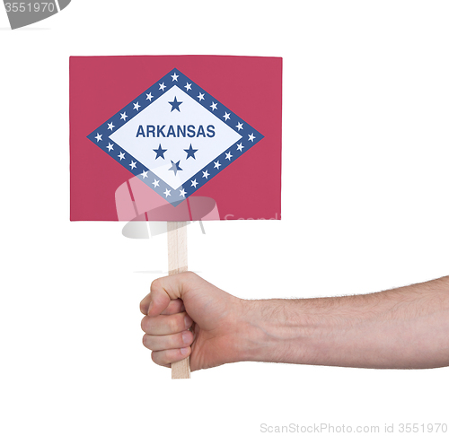 Image of Hand holding small card - Flag of Arkansas