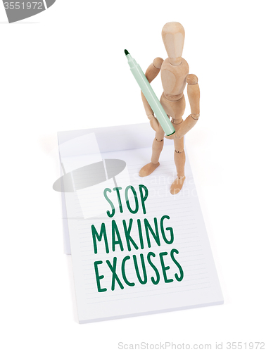 Image of Wooden mannequin writing - Stop making excuses