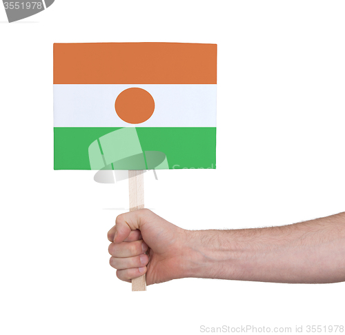 Image of Hand holding small card - Flag of Niger