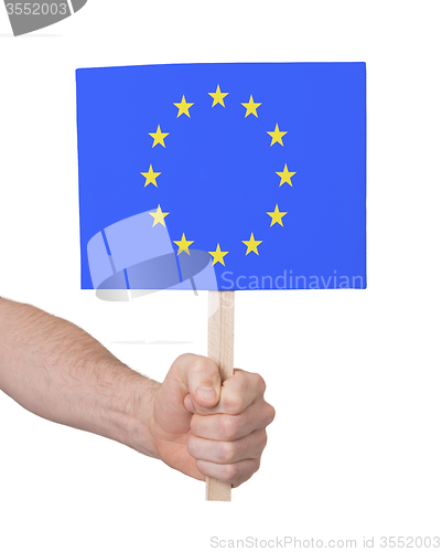 Image of Hand holding small card - Flag of the European Union