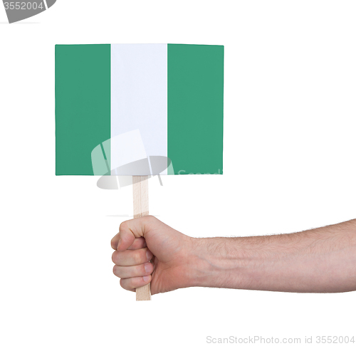 Image of Hand holding small card - Flag of Nigeria