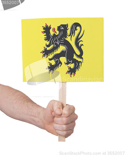 Image of Hand holding small card - Flag of Flanders