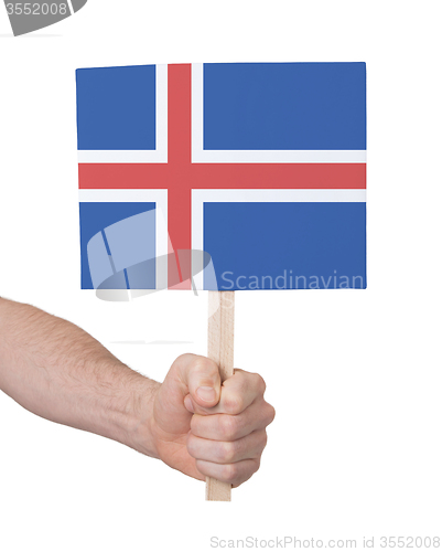 Image of Hand holding small card - Flag of Iceland