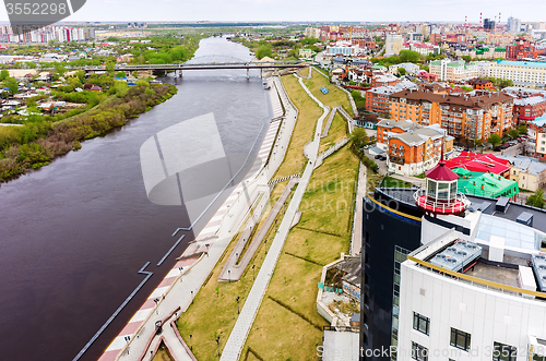 Image of Pedestrian quay and bridge over Tura river. Tyumen