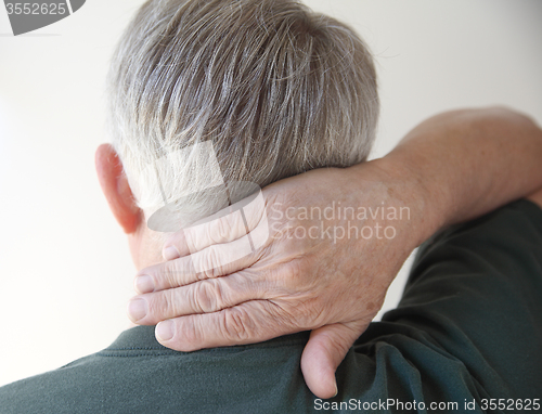 Image of senior man with hand on neck   