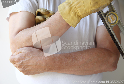 Image of painful elbow on workman	