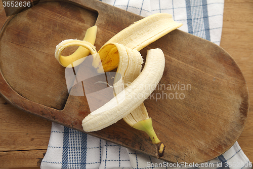 Image of peeled banana on cutting board