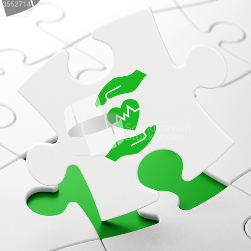 Image of Insurance concept: Heart And Palm on puzzle background