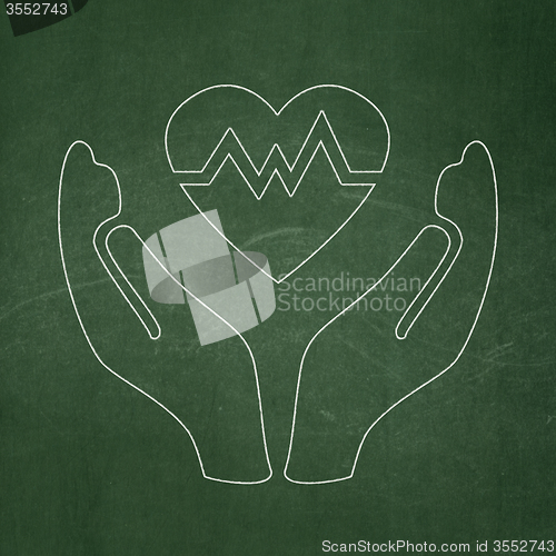 Image of Insurance concept: Heart And Palm on chalkboard background