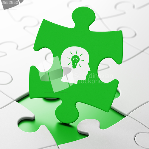 Image of Studying concept: Head With Light Bulb on puzzle background