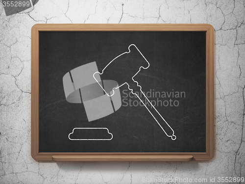 Image of Law concept: Gavel on chalkboard background