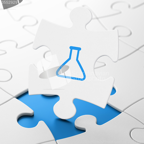 Image of Science concept: Flask on puzzle background