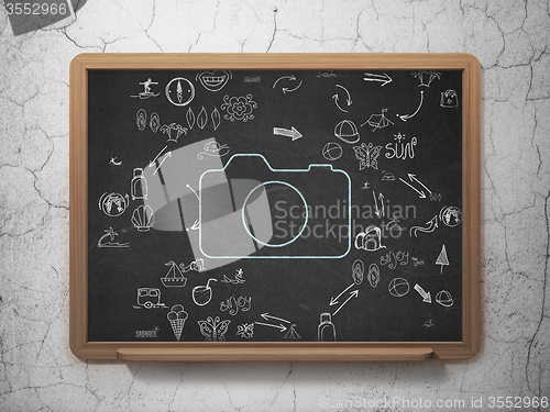 Image of Travel concept: Photo Camera on School Board background