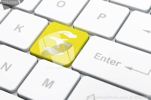 Image of Insurance concept: Airplane And Palm on computer keyboard background