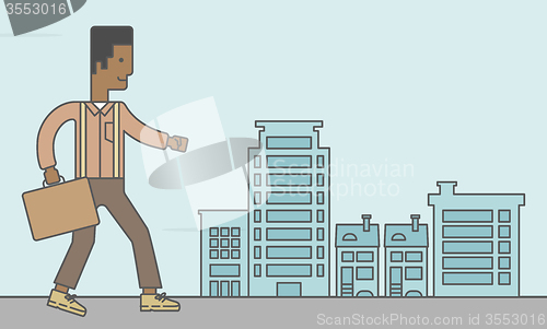 Image of Businessman walking with briefcase. 