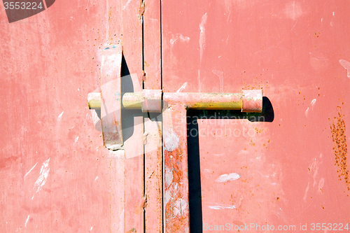 Image of red  in africa the old wood  facade home and safe padlock 