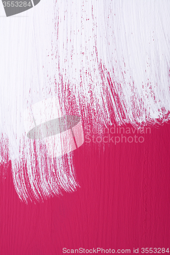 Image of Pink board being roughly painted with white paint