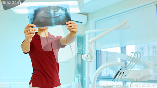 Image of doctor or dentist looking at x-ray