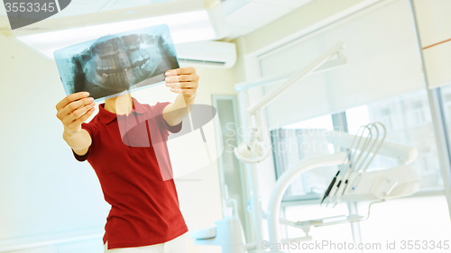 Image of doctor or dentist looking at x-ray