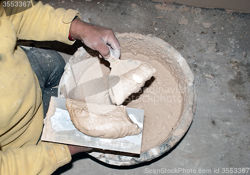 Image of plasterer gaining mixture