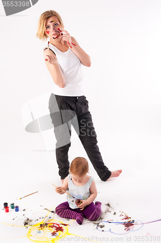 Image of Pretty young mother and daughter draw picture