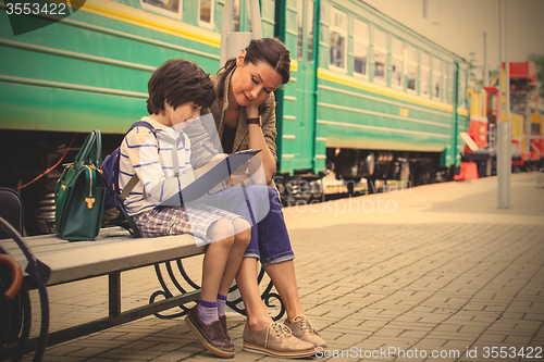 Image of Mother and son on the railway station