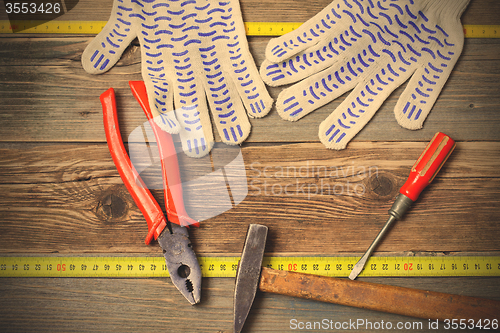 Image of old pliers, hammer and screwdriver